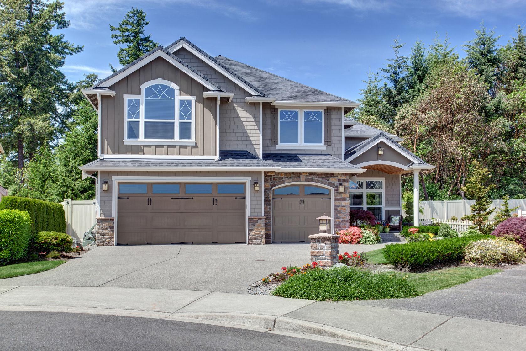 59954855 - home exterior with garage and driveway with nice landscaping desing around