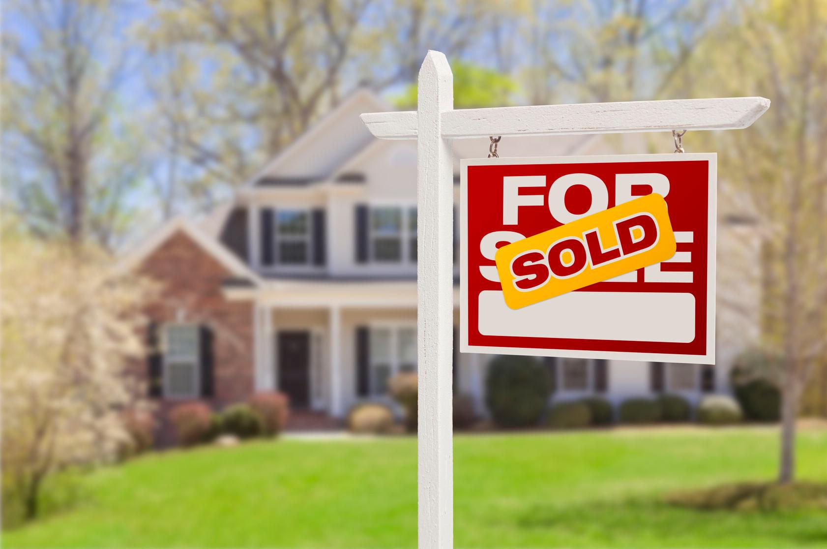 24552401 - sold home for sale real estate sign in front of beautiful new house.