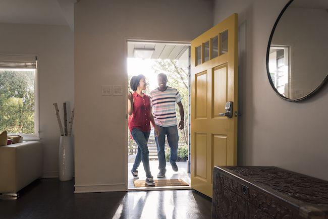 Couple walking into a house.
